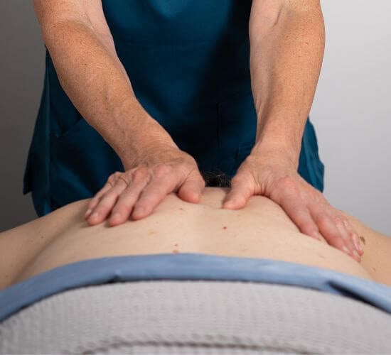 therapist works on a client's back during a myofascial massage