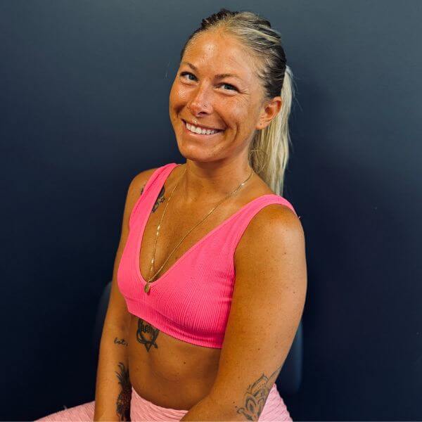 Brianna D'ambrosio, yoga instructor at Wellness Hot Yoga smiling for a photo